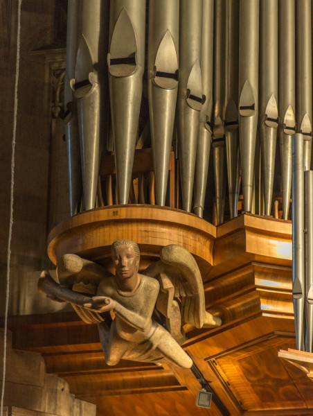 A detailed photo of an angel to the left of the Giant Organ.